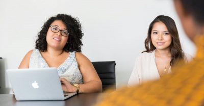 Two females at a desk interviewing a candidate