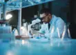 image of a person looking through a microscope research